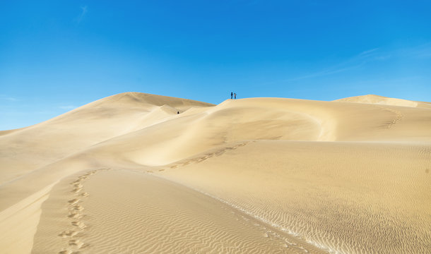 Tourists on the slope of the Dune 7 in Sossusvlei plato of Namib Naukluft National Park - Namibia, South-West Africa