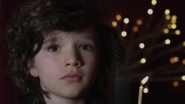 4k Shot of a Cute Child in Studio Blowing a Candle (Birthday Wish)