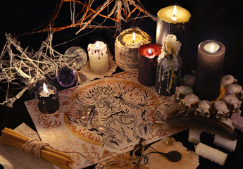 Mystic still life with demon drawing and black candles