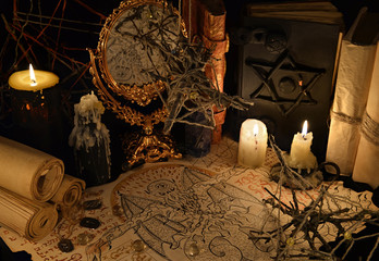Mystic still life with demon manuscript and magic books
