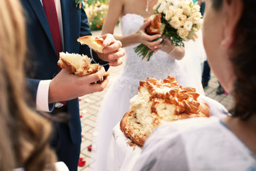 Traditional wedding bread with salt. Groom holding piece of bread
