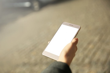 Woman holding modern cellphone, outdoor