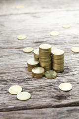 Stack of coins on wooden surface showing growth