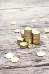 Stack of coins on wooden surface showing growth