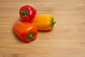 Sweet peppers on wooden cutting board
