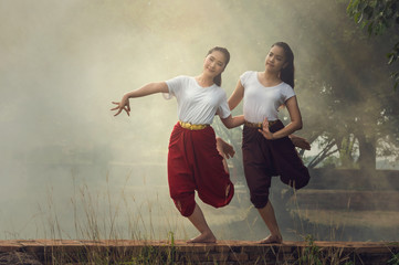 Two Beautiful young girl Thai Dancing art, pantomime performance