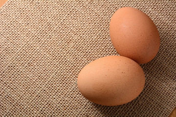 Fresh chicken egg on sackcloth