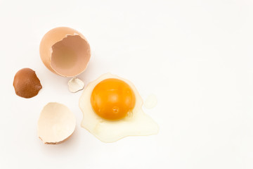 Raw egg cracked on white background