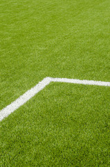 Obraz premium The white Line marking on the artificial green grass soccer field