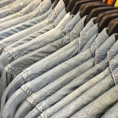 Denim Shirts hanging on a rack in the store.

