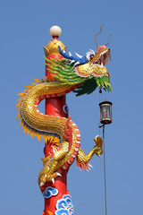 The Chinese dragon statue with blue sky background.