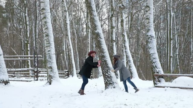 loving happy young couple emotionally runs in the winter woods.