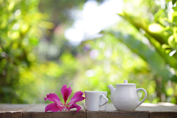 white vintage teapot with cup and flower