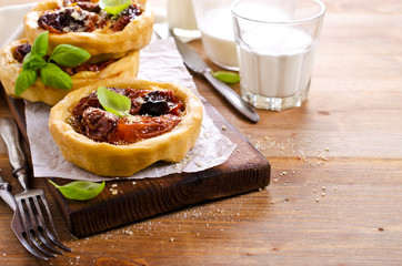 Open pies with dried tomatoes