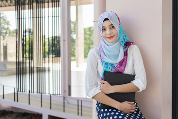 Muslim woman standing with document paper