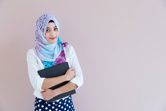 Muslim woman standing with document paper.