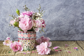 Pink carnation in mosaic flower pot