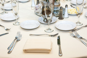 White table setting. Nife, fork, glass. Wedding decoration