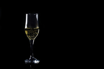 tulip glass of champagne on a black background