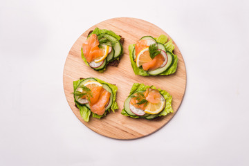 Four sandwich on a wooden board