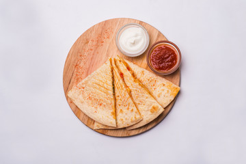 Quesadilla on a wooden table close-up shot
