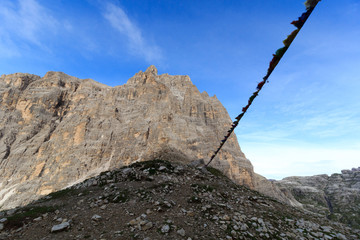 Mountain at Col Giralba and prayer flag in Sexten Dolomites, South Tyrol, Italy