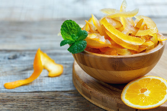 Bowl With Candied Citrus Fruits And A Sprig Of Mint.