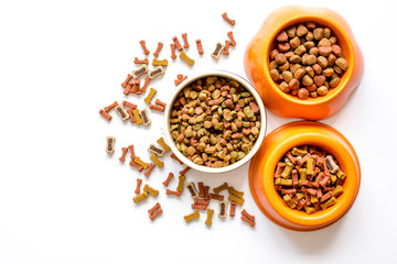 dry dog food in bowl on white background top view