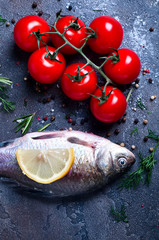 Delicious fresh fish on dark vintage background.