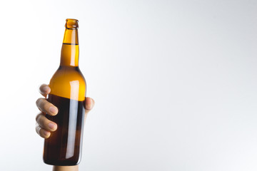 Hand holding a beer bottle
