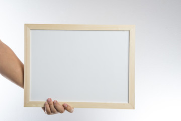 Hand holding blank wooden frame