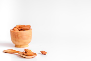 cosmetic almond oil in glass bottle on white background
