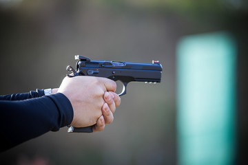 Hand holding a gun.