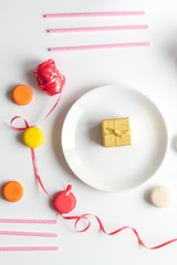 Gift box with colorful party items white background top view