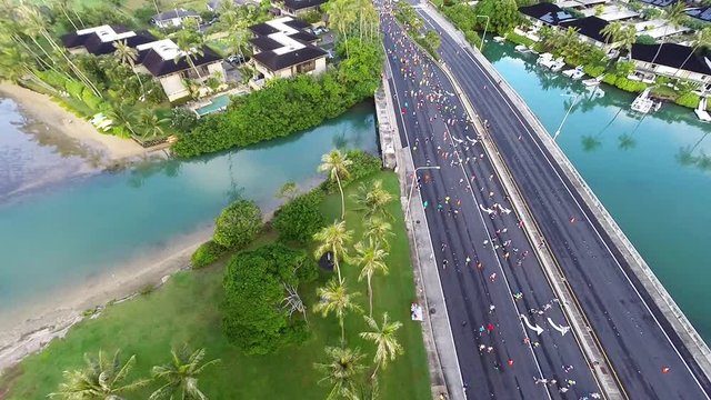 Aerial video of runners of a marathon in Honolulu as they traverse through Hawaii Kai, about 10 miles from the finish