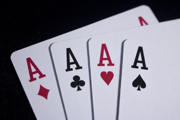 four of a kind poker card on dark black background
