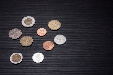 Coins of the world on the wooden table
