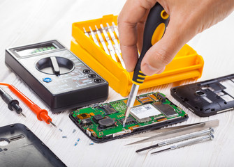 repair and testing smartphone with a multimeter
