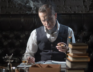 Business man in his office smoking a cigar