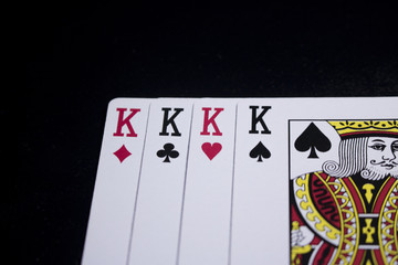 four of a kind king poker card on dark black background