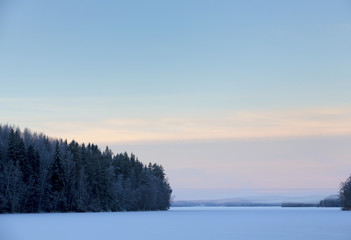 Fototapeta premium Pastel colored morning during winter. Colorful landscape, foggy mountains in the background.
