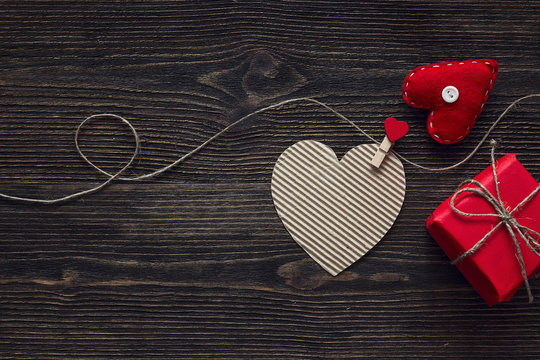 Valentine's day concept with gift box and  hearts on dark wooden