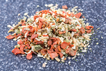 Vegetable soup mix on a mottled grey blue background