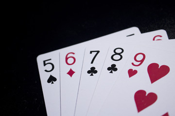straight poker card on dark black background