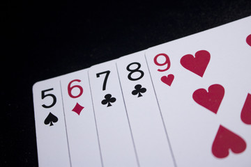 straight poker card on dark black background