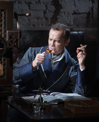 Man with a pistol at a desk writing a letter