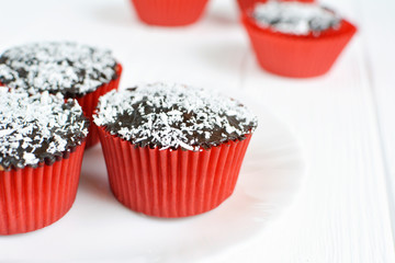 Homemade cupcakes with chocolate glaze and coconut