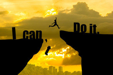 Man jumping on I can do it or I can't do it text over cliff on sunset background,Business concept...