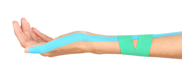 Physiotherapy concept. Female hand with physio tape on white background