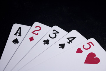 Obraz premium straight poker card on dark black background